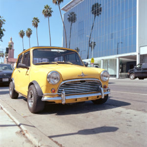 Yellow classic Mini Cooper parked on Sunset Blvd