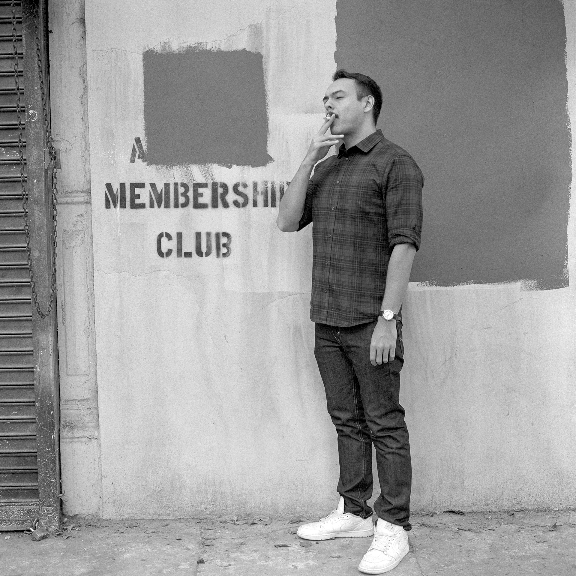 Full length portrait of musician Eat Paint smoking a cigarette in downtown Los Angeles